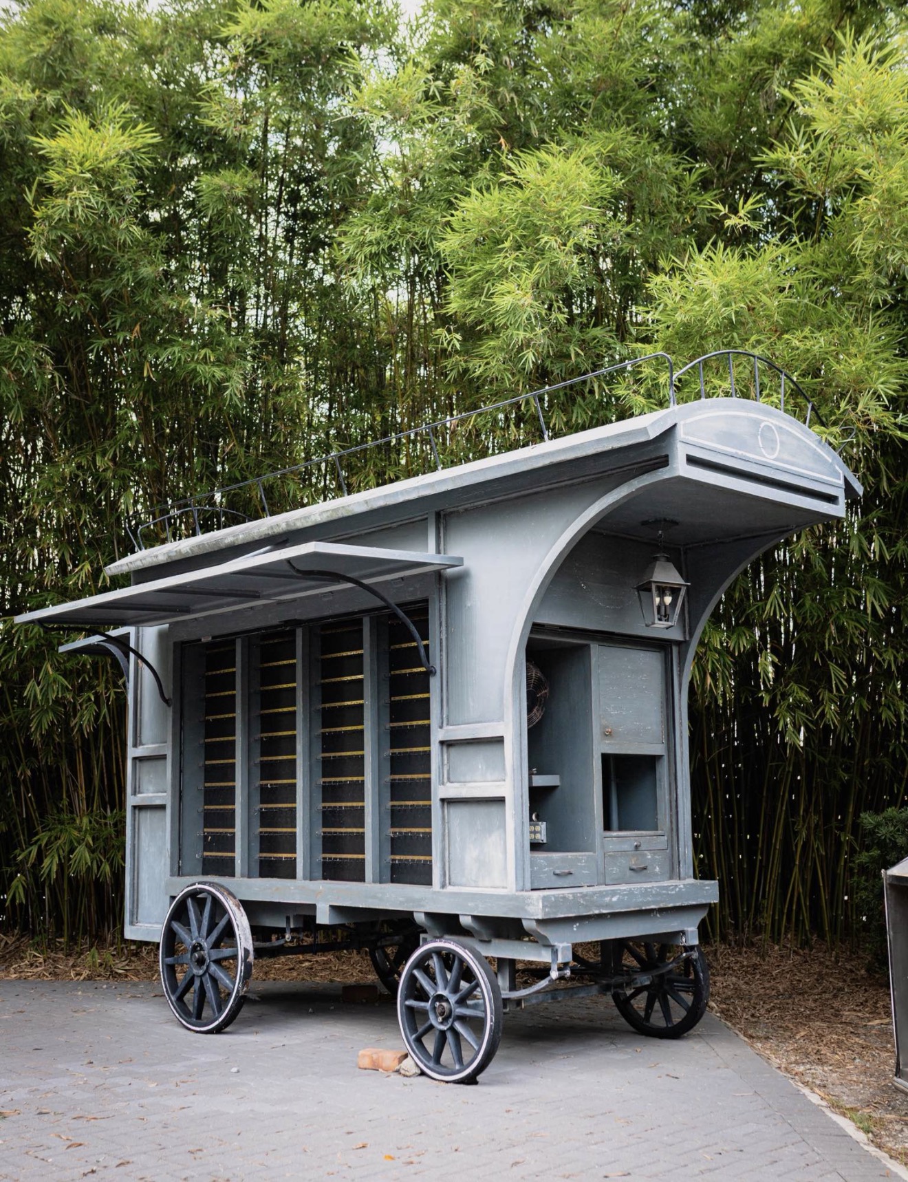 Empty Harry Potter theme park wagon for sale in Winter Park, Florida, a Victorian-style timber market carriage in front of bamboo